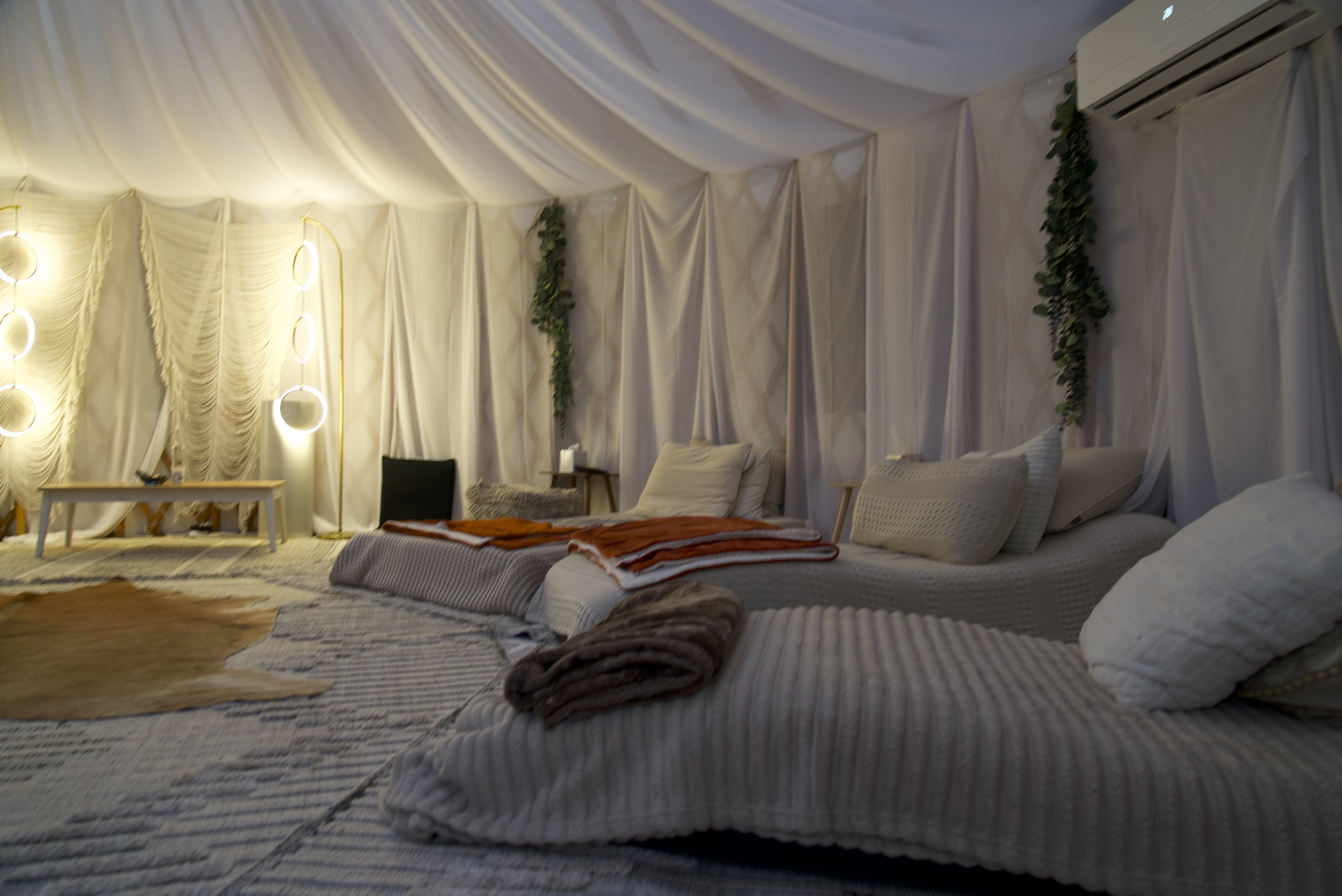 Dome interior with beds, pillows, and fairy lights